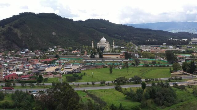 View from a drone of an amusement park near a small country town surrounded by roads and mountains. Colombia
