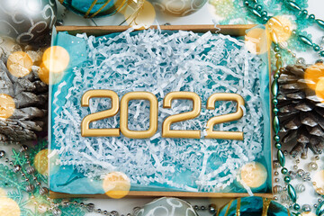 christmas empty cardboard box with blue backing and white paper filling with the numbers 2022