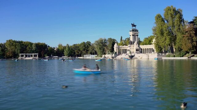 Tourists on boats in Parque del Buen Retiro lake on a sunny day in Madrid, Spain. High quality 4k footage