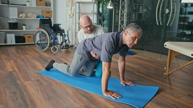 Physiotherapist Conducting a Rehabilitation Session For a Man with a Brain Stroke. Recovery in a Rehabilitation Center, Improving the Quality of Life of a Person with a Disability.