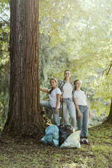 Young women cleaning up the forest