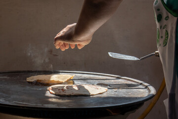 young hand making mexican tortillas
