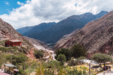 Fototapeta na wymiar terraces of salineras de maras located in the sacred valley of the incas surrounded by vegetation on a sunny summer day in peru