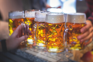 View of beer festival, gold coloured beer glasses assortment in a pub, german unfiltered wheat...