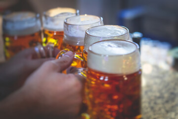 View of beer festival, gold coloured beer glasses assortment in a pub, german unfiltered wheat...