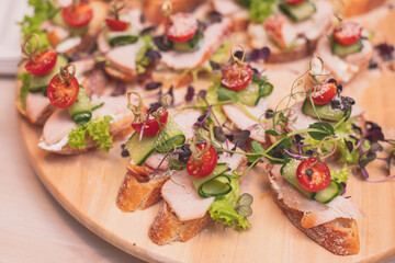 Catering table buffet dinner, beautifully decorated banquet with variety of different food snacks and appetizers on corporate birthday party event or wedding reception, canape, delicatessen setting