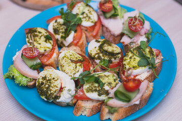 Catering table buffet dinner, beautifully decorated banquet with variety of different food snacks and appetizers on corporate birthday party event or wedding reception, canape, delicatessen setting