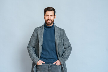 Handsome successful caucasian businessman in formal suit portrait on blue
