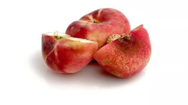 sliced flat peach on white background