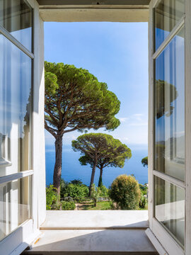 Window view of a garden with pine trees at Villa Rufolo, Ravello, Capri, Italy