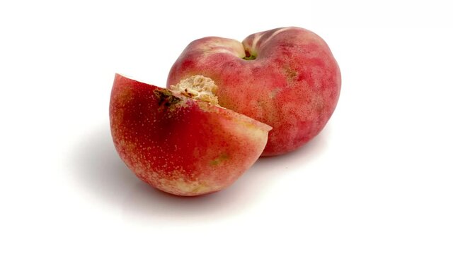 sliced flat peach on white background