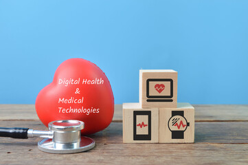 Red heart shape, stethoscope and wooden blocks with digital health and medical technologies symbol