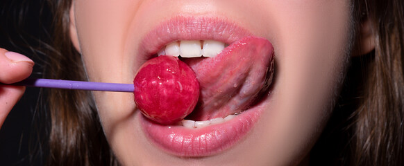 Close up, model licking a red lollipop - obrazy, fototapety, plakaty