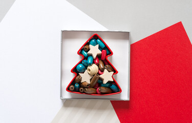 tree shaped christmas cookie cutter inside a shallow paper box