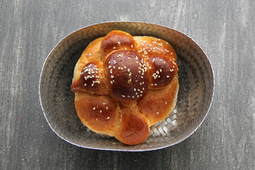 Delicious, fluffy and freshly made at home pan de muerto with sesame seeds sprinkled as a Mexican tradition for the Day of All Souls and All Saints which is celebrated in November
