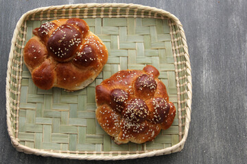 Delicious, fluffy and freshly made at home pan de muerto with sesame seeds sprinkled as a Mexican tradition for the Day of All Souls and All Saints which is celebrated in November

