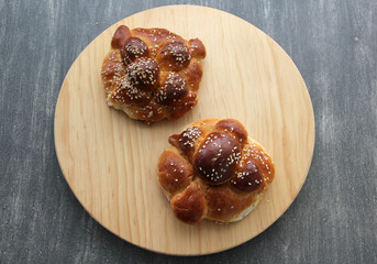 Delicious, fluffy and freshly made at home pan de muerto with sesame seeds sprinkled as a Mexican tradition for the Day of All Souls and All Saints which is celebrated in November
