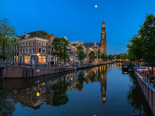 Fototapeta na wymiar Buildings Reflecting on Canal in Amsterdam