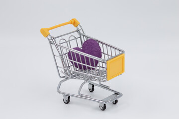 Model metal shopping cart, purple sponge heart inside