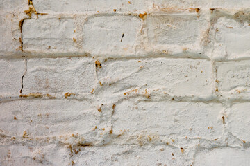 Close up view of rustic whitewashed brick wall