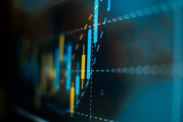 Closeup of financial stock chart with uptrend line candlestick graph on blue color screen.