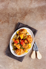 Ayam Koloke or Kuluyuk Chicken, is a Chinese Indonesian dish made from crispy chicken seasoned with red sweet and sour pineapple sauce. Popular as Ayam Asam Manis