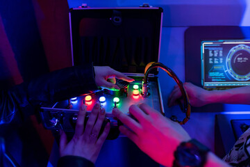Female and male hands reach for a suitcase with wires and switches. Quest game.