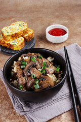 Nasi jamur. Rice mushroom or risotto with rice and mushrooms, served with rolled omelette.