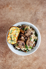 Nasi jamur. Rice mushroom or risotto with rice and mushrooms, served with rolled omelette.