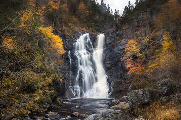 North River waterfalls, the highest waterfall of Nova Scotia  Gushing water fall in an autumn forest landscape. North River Falls, Cape Breton, Nova Scotia, Canada