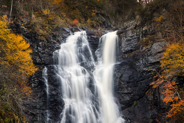 Fototapeta na wymiar North River waterfalls, the highest waterfall of Nova Scotia Gushing water fall in an autumn forest landscape. North River Falls, Cape Breton, Nova Scotia, Canada