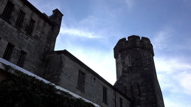 Medieval style building silhouetted against evening sky.