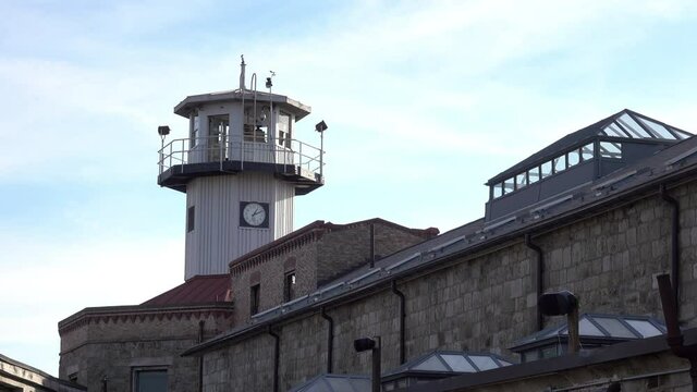 Penitentiary guard tower and cellblock with multiple skylights.