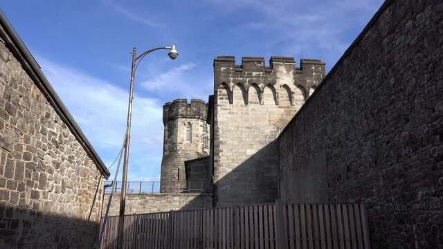 Long shot of medieval style wall, towers and parapet at Eastern State Penitentiary.