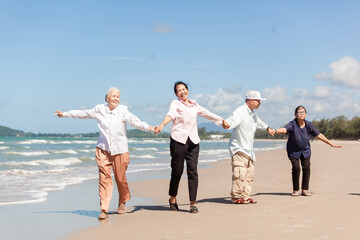 Happy family having fun on the beach. asian people senior couple happy and relax on the beach. Family vacation holiday