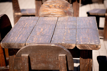 Old wooden table with chairs.