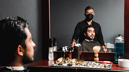 Barber and customer looking at the mirror
