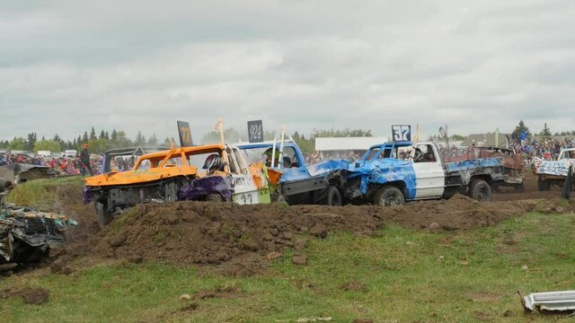 Trucks smashing into each other at demolition derby