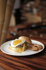 burger and fried eggs on a plate 