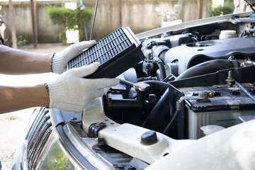 Manual car air filter replacement to maintain engine performance.Air filter is clogged. Causing...
