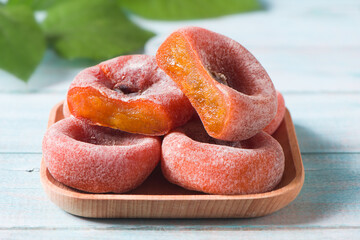 dried persimmon on blue wood background
