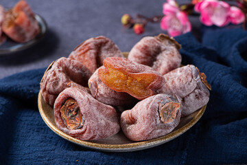 dried fruit persimmon on wood background