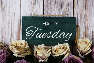 Happy Tuesday typography text with roses flowers bouquet on wooden background