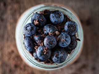 Healthy chia pudding with blueberries in jar on the rustic background. Selective focus. Shallow depth of field.
