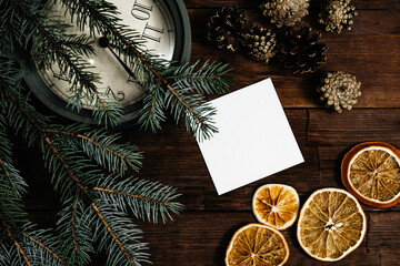 concepts of Christmas and New Year. Wooden table with clock, Christmas tree, oranges. Place for the inscription.