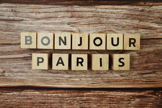 Bonjour Paris Word alphabet letters on wooden background