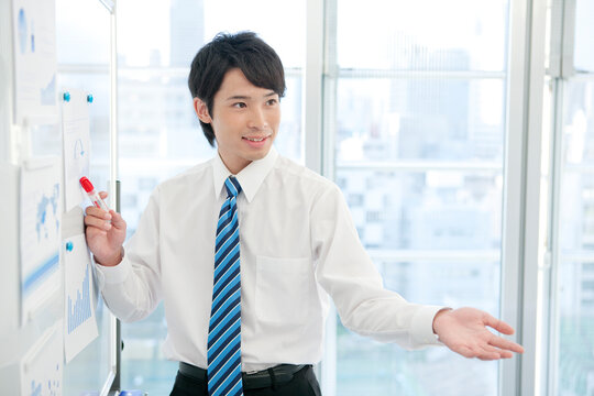 ホワイトボードの前に立つビジネスマン