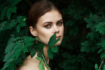 portrait of a woman green leaves clean skin nature summer close-up
