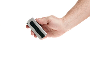 Hand holds a remote control on a white background, template for designers.