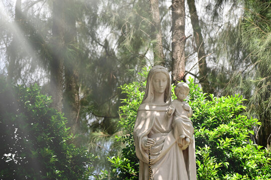 Statue of Our lady and child Jesus catholic church with natural background. at thailand